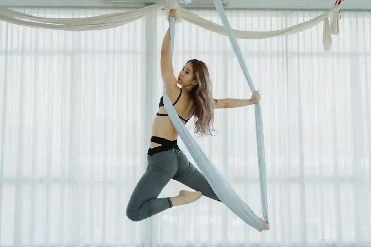 Woman performing aerial yoga